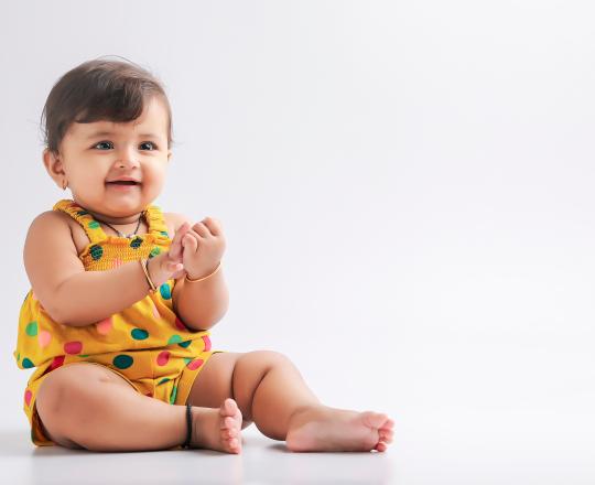baby girl in yellow outfit