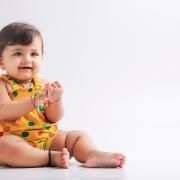 baby girl in yellow outfit